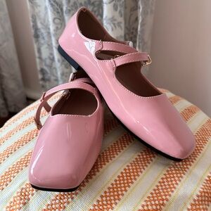 Pink Mary Jane flats with buckle closure